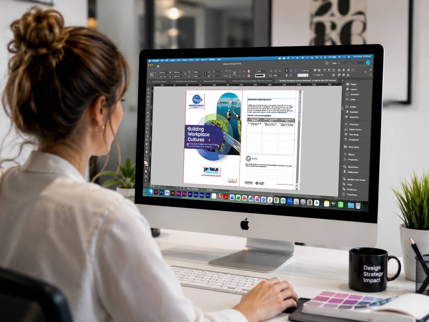 A designer working on a Proteus Productions program in Adobe InDesign