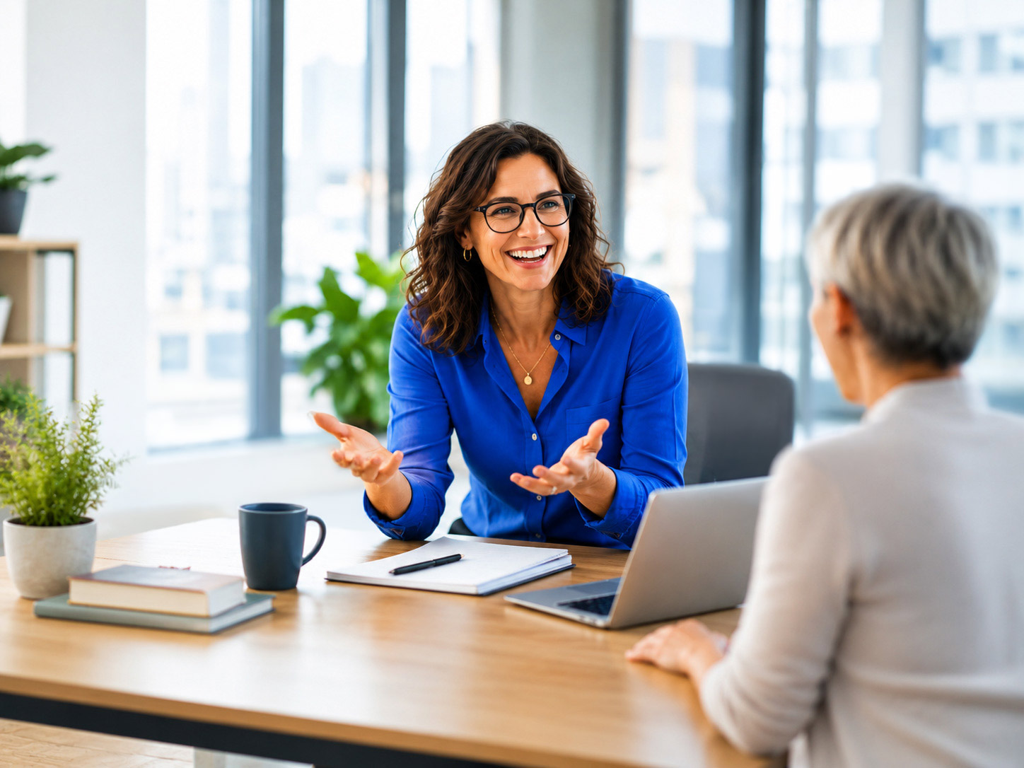 A Proteus consultant meeting with a client to discuss their leadership program